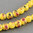 Porceleinen kralen, rond 8mm, geel met bloemen. Verkocht per streng van ca. 40mm (50 kralen)